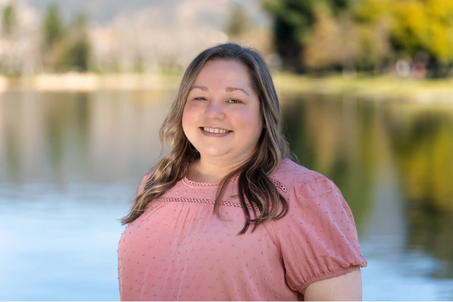 young woman in pink top smiling
